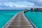 A wooden pier towards the water villas