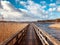 Wooden pier at waterside - straight wood dock walkway at lake