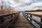 Wooden pier at waterside - straight wood dock walkway at lake