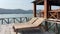 Wooden pier with wooden chairs flowers and sea view South East Asia