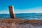 Wooden pile washed by the blue waters of the lake