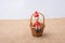 Wooden Pinocchio doll sitting mini basket