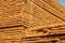 Wooden planks at lumber warehouse. Woodworking industry. Wooden boards