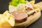 wooden plate with cheeses and cold cuts like gruyere, mortadella, Roquefort and prosciutto