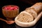 Wooden plate with fresh sliced bread, cup with raspberries and s