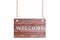 Wooden plate of worn brown boards hangs on a metal chain. White isolate With welcome sign