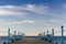 Wooden platform with blue posts with ropes and orange lifebuoys on the background of the sea and sky with clouds Egypt Dahab South