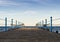 Wooden platform with blue posts with ropes and orange lifebuoys on the background of the sea and sky with clouds Egypt Dahab South