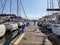 Wooden platform separate docked yachts with masts at Alimos Marina, Athens, Greece