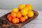 Wooden platter with mandarins and oranges, a healthy citrus symphony