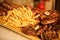 Wooden platter with roast and french fries