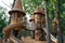 A wooden play structure with a slide is seen in a community park, providing children with an interactive recreational area, A