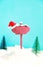 Wooden pointer and Santa`s hat on a blue background