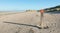 Wooden pole on an empty beach at the North Sea