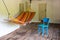 Wooden porch of an old vintage country house with tables, chairs and hammock - a place for eating and relaxing