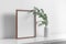 Wooden portrait frame mockup in white room interior with eucalyptus plant in vase