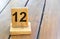 Wooden priority number 12 on a plank tab