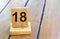 Wooden priority number 18 on a plank tab