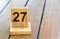 Wooden priority number 27 on a plank tab