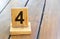 Wooden priority number 4 on a plank tab