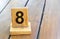 Wooden priority number 8 on a plank tab