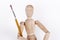 Wooden puppet holding painting brush