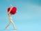 Wooden puppet walking and hold red heart on the sky blue screen background. Wooden puppet handle the heart with love and care. Con