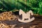 Wooden puzzle in the form of a handmade horse on the background of the forest.