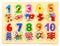 Wooden puzzle with numbers and arithmetic signs with pictures of items. Children`s hand takes the figures from the