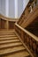 Wooden railings and wooden stairs in the interior of a spacious building