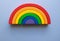 Wooden rainbow toy on a blue background