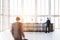 Wooden reception desk in loft office, people