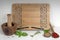 Wooden recipe book stand with mortar and pestle, herb leaves and dried spices