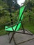 Wooden recliner chair featuring lush green fabric