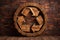 Wooden recycling logo on a dark wooden background. ecological concept