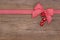 Wooden red christmas background with a white checked ribbon