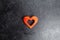 Wooden red heart on a gray concrete background. Heart shape, a metaphor for love and human feelings. The concept of love
