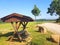 Wooden resting spot with banks, table and top