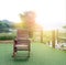 Wooden rocking chair on green grass in the garden