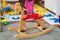 Wooden rocking horse. Children toy in messy children`s room