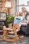 wooden rocking horse and happy family reading book behind 1950s