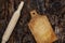 Wooden rolling pin and cutting board on a dark burnt wooden surf