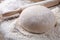 Wooden rolling pin with dough and dusting of flour