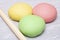 Wooden rolling pin near colorful dough, close up