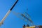 Wooden roof with crane holds a roof truss beams