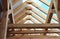 Wooden roof framing with a close-up of rafters, roof beams and purlins framing during roofing construction