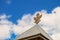 Wooden roof with historical coat of arms of the Russian Empire under blue sky