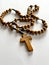 wooden rosary lying on a sheet of paper