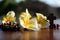 Wooden rosary with sun rays over Jesus Christ cross crucifix and flowers decoration background. Christian catholic religion