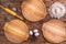 Wooden round pizza boards, chicken eggs, a mound of wheat flour and a rolling pin on a brown board background